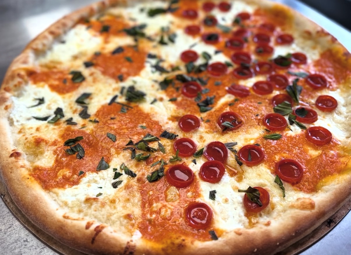Freshly baked pepperoni and basil pizza from Fat Guy New York Style Pizza